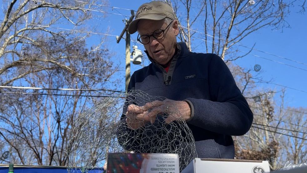 Jonathan Smith making a lighted ball out of chicken wire.